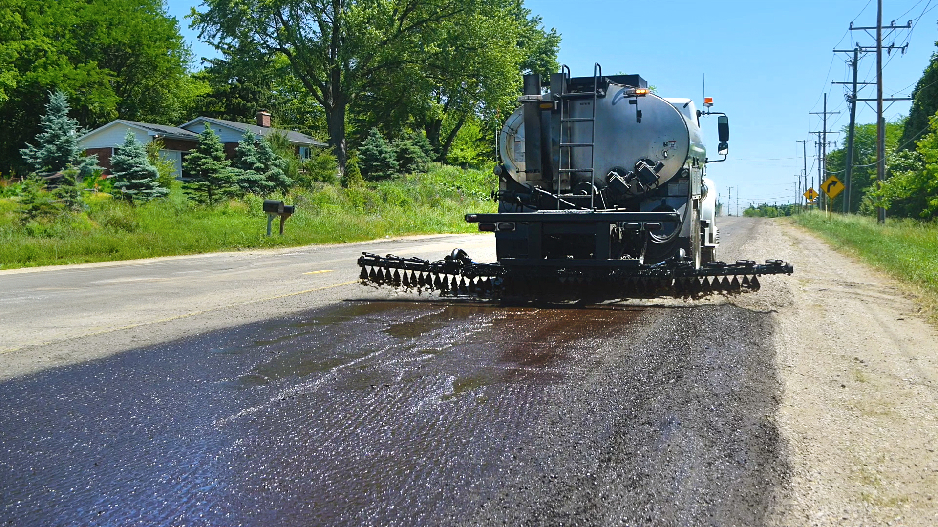 truck distributes tack cost on a road